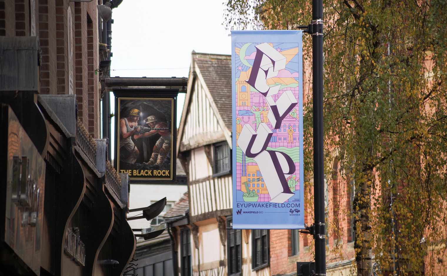 'Ey Up Wakefield' City Centre Lamppost Flag Banners for Wakefield BID - View of Cross Street